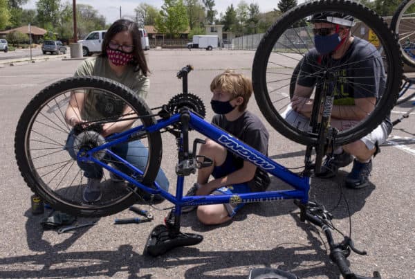 A child learns to repair a bicycle