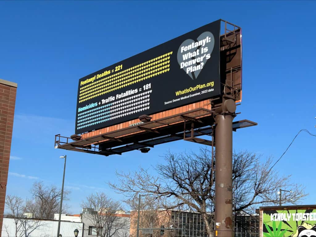 A billboard showing fentanyl deaths outpacing traffic fatalities and homicides in Denver.