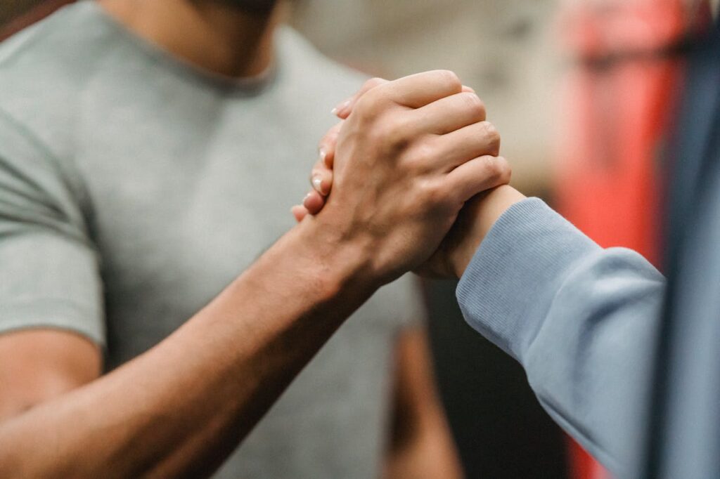 Two people reaching out for one another