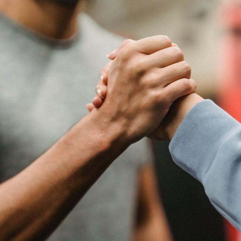 Two people reaching out for one another