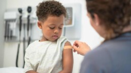 Doctor putting bandaid on child