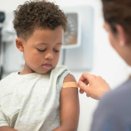 Doctor putting bandaid on child