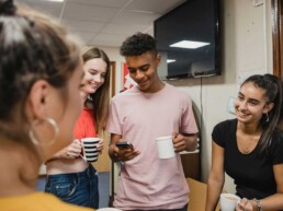 Group of youth in a classroom hanging out