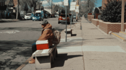 Man sitting on bench waiting for bus